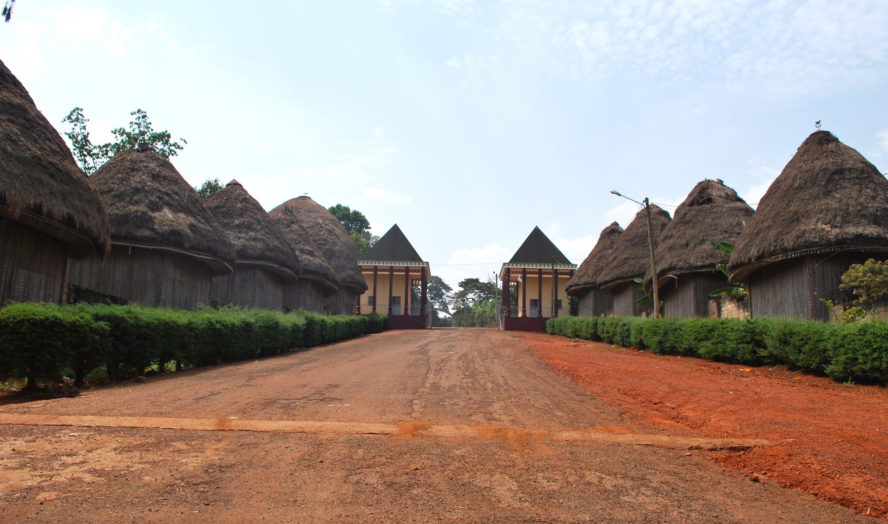 The courtyard of the Bandjoun palace and its royal houses.